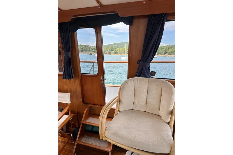  Yacht Photos Pics Interior of 1987 Albin North Sea Trawler with scenic water view through windows.