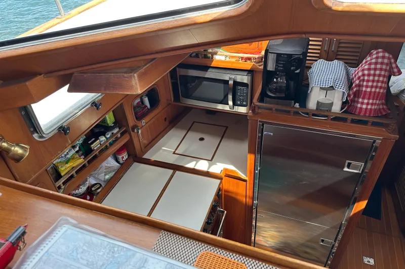  Yacht Photos Pics 1987 Albin North Sea Trawler galley with microwave, coffee maker, and storage cabinets.