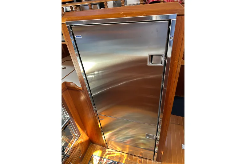  Yacht Photos Pics Stainless steel refrigerator on 1987 Albin North Sea Trawler, wooden interior.