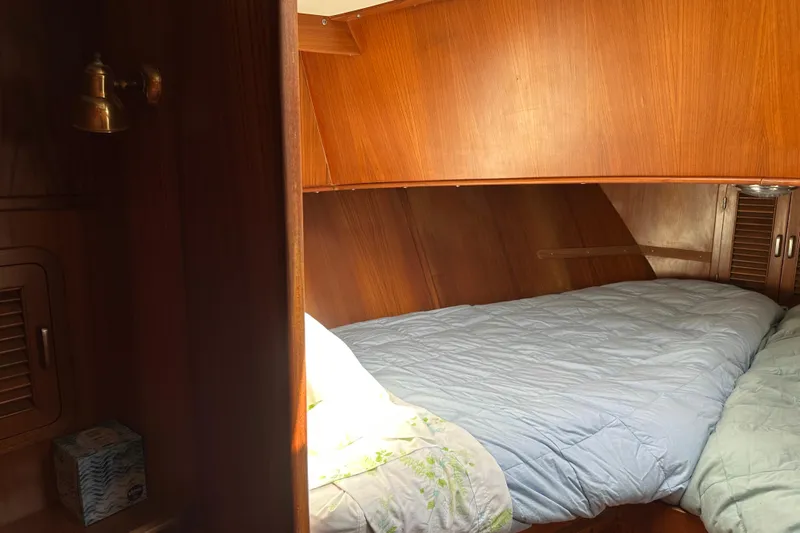  Yacht Photos Pics Cozy cabin interior of 1987 Albin North Sea Trawler with wooden paneling and bedding.
