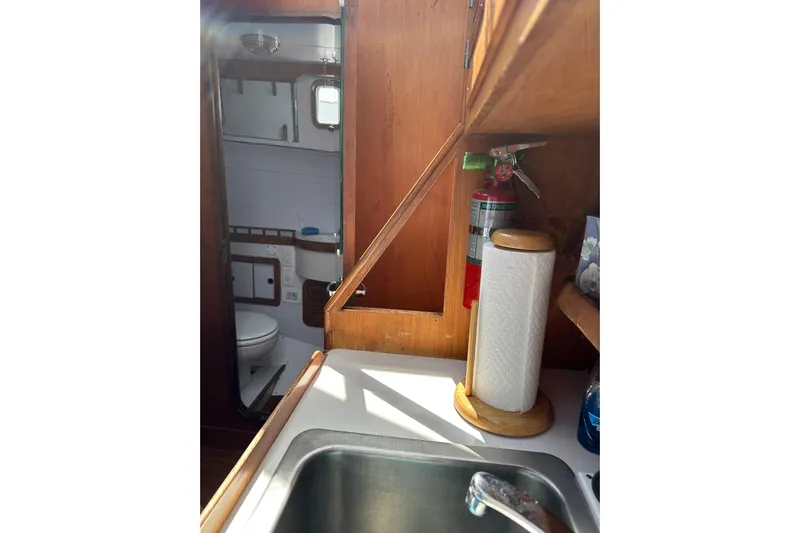  Yacht Photos Pics 1987 Albin North Sea Trawler interior with sink, paper towel holder, and visible bathroom.