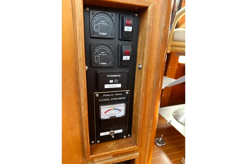  Yacht Photos Pics Control panel of a 1987 Albin North Sea Trawler with gauges and electrical system monitor.