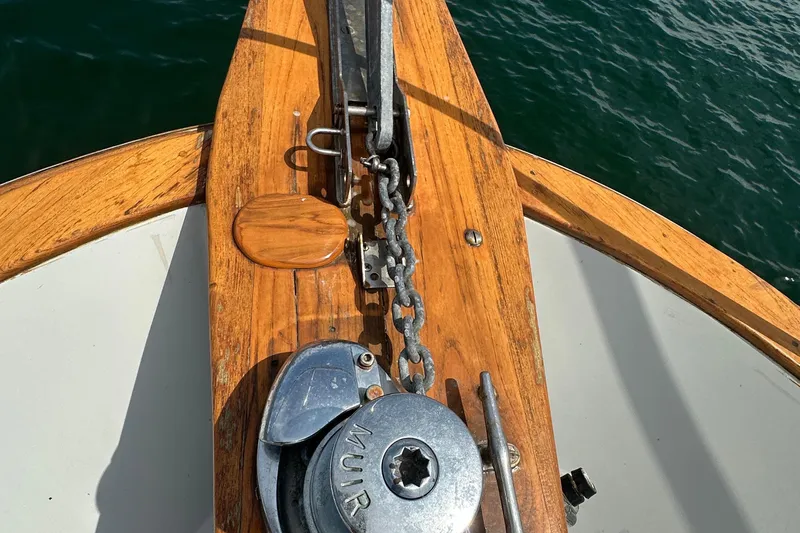  Yacht Photos Pics Anchor and windlass on 1987 Albin North Sea Trawler, wooden deck, ocean background.