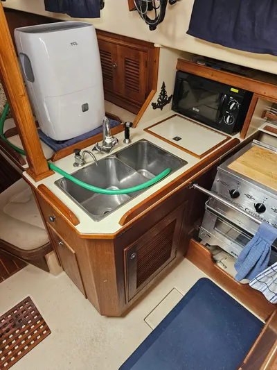 Moon River Yacht Photos Pics 2002 Island Packet 350 yacht kitchen with sink, microwave, and stove.