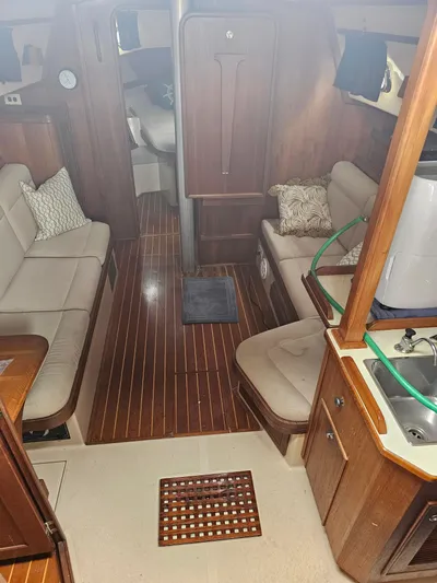 Moon River Yacht Photos Pics Interior of 2002 Island Packet 350 sailboat with wood flooring and cozy seating.