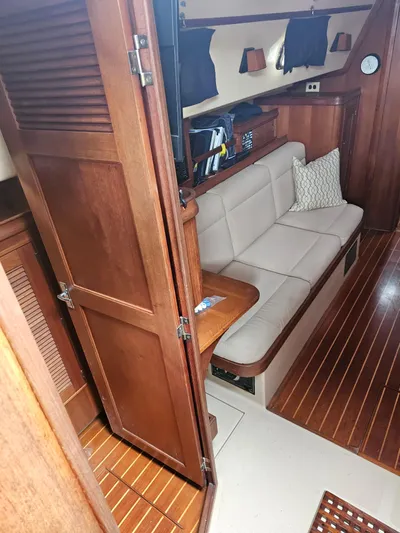 Moon River Yacht Photos Pics Interior of 2002 Island Packet 350 sailboat with wooden finishes and cozy seating area.