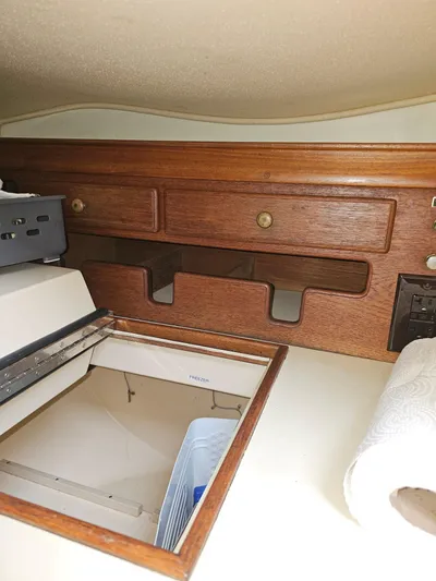 Moon River Yacht Photos Pics Interior of 2002 Island Packet 350 sailboat with wooden cabinetry and storage space.