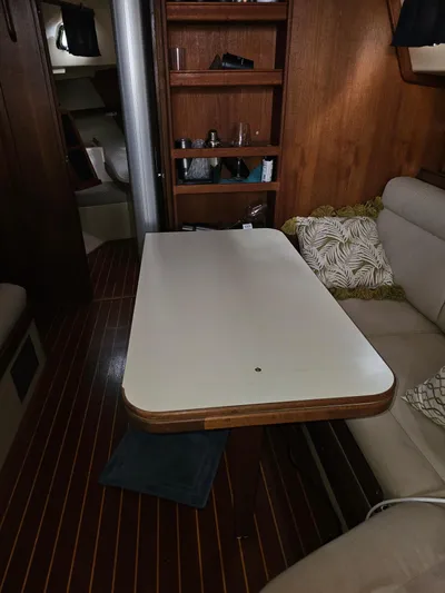 Moon River Yacht Photos Pics Interior of 2002 Island Packet 350 sailboat with table and seating area.