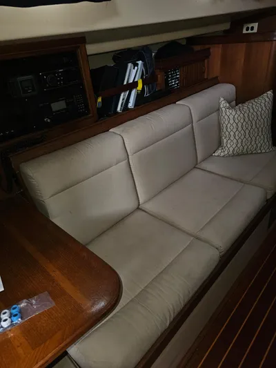Moon River Yacht Photos Pics 2002 Island Packet 350 interior with beige sofa and wooden accents.