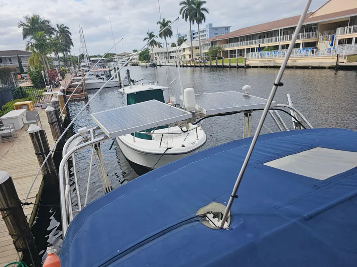 Moon River Yacht Photos Pics 2002 Island Packet 350 sailboat docked with solar panels, marina view.