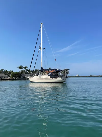 Moon River Yacht Photos Pics 2002 Island Packet 350 sailboat on calm water under clear blue sky.