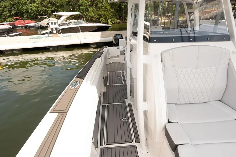  Yacht Photos Pics 2018 Fountain 38 SCX boat interior with sleek seating and dock view.