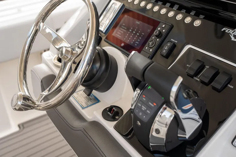  Yacht Photos Pics Steering console of 2018 Fountain 38 SCX boat with modern controls and display.