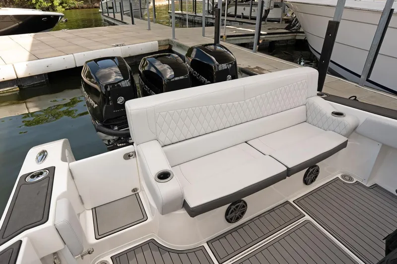  Yacht Photos Pics 2018 Fountain 38 SCX boat with white seating and triple outboard engines at dock.