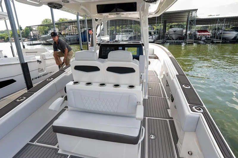  Yacht Photos Pics 2018 Fountain 38 SCX boat interior with seating and dashboard, docked at marina.