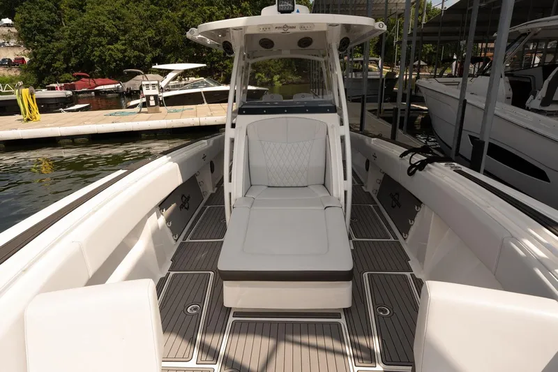  Yacht Photos Pics 2018 Fountain 38 SCX boat interior with sleek seating and modern design at a marina.