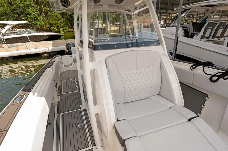  Yacht Photos Pics 2018 Fountain 38 SCX boat interior with white seating and sleek design at a marina.