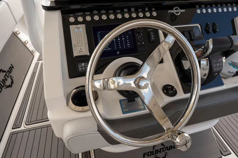  Yacht Photos Pics Steering wheel and controls of a 2018 Fountain 38 SCX boat cockpit.