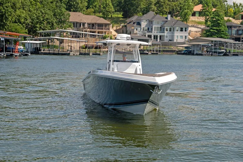  Yacht Photos Pics 2018 Fountain 38 SCX boat cruising on a scenic lake near waterfront homes.