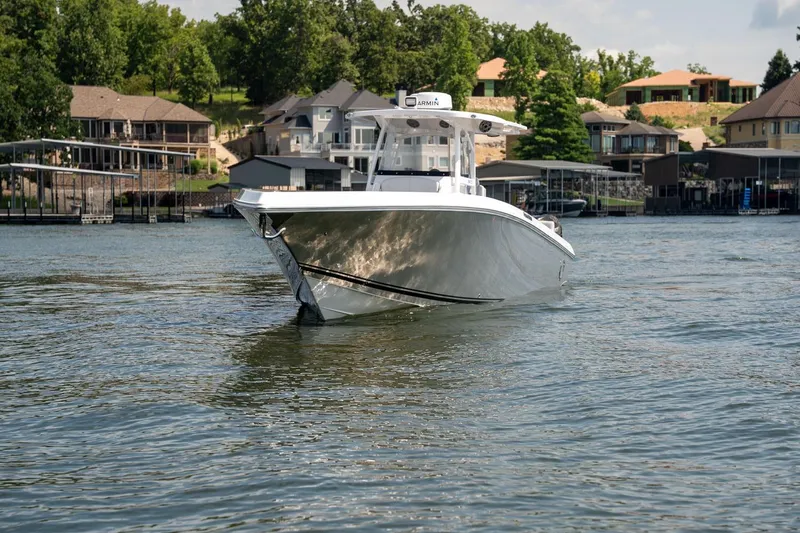  Yacht Photos Pics 2018 Fountain 38 SCX boat cruising on a lake near waterfront homes.