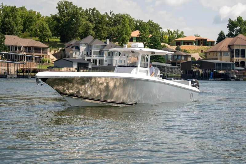  Yacht Photos Pics 2018 Fountain 38 SCX boat cruising on a lake near luxury waterfront homes.