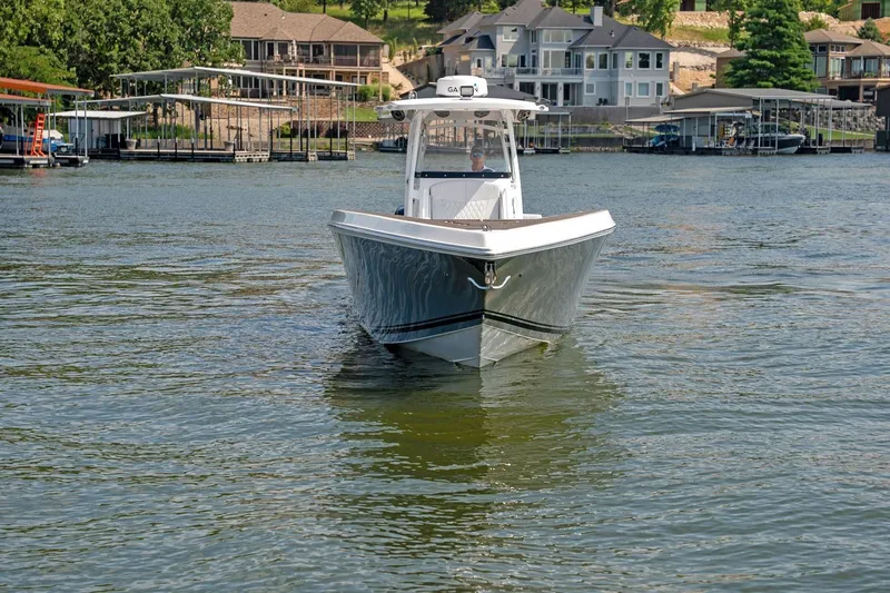  Yacht Photos Pics 2018 Fountain 38 SCX boat on a lake with waterfront homes in the background.