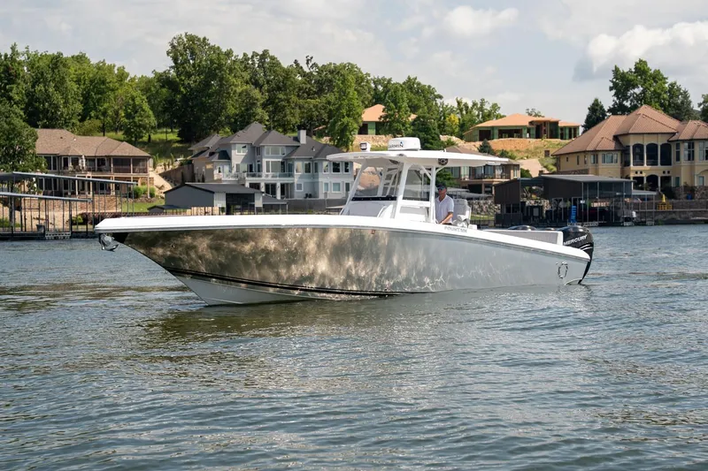  Yacht Photos Pics 2018 Fountain 38 SCX boat cruising on a scenic lake near luxury homes.