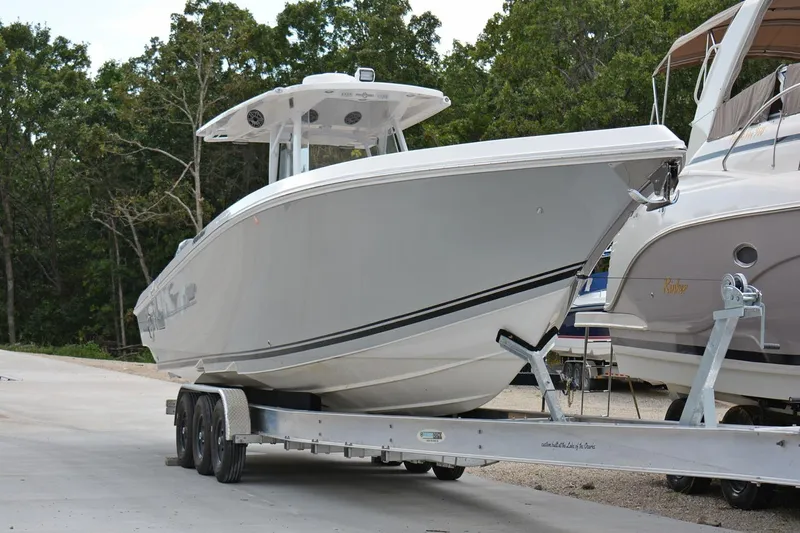  Yacht Photos Pics 2018 Fountain 38 SCX boat on trailer, parked outdoors near trees.