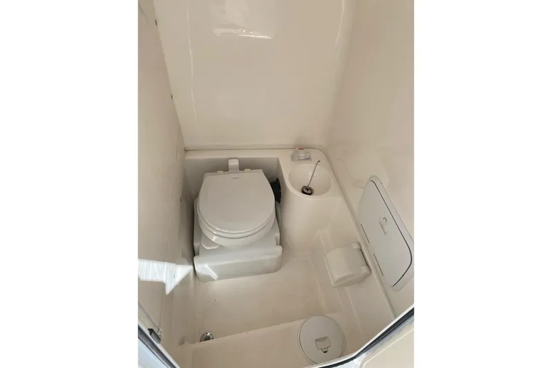  Yacht Photos Pics 2018 Fountain 38 SCX boat bathroom with toilet and storage compartments.