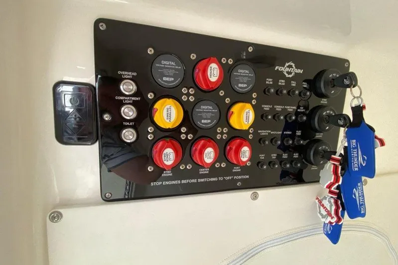  Yacht Photos Pics Control panel of a 2018 Fountain 38 SCX boat with switches and keychains.