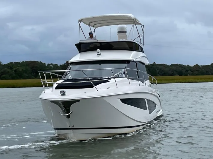 Grateful Yacht Photos Pics 2022 Regal 42 FXO yacht cruising on a calm river.