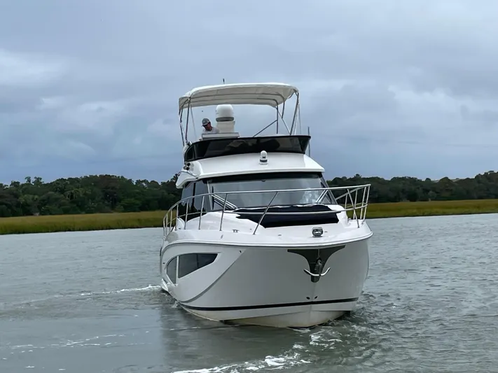 Grateful Yacht Photos Pics 2022 Regal 42 FXO yacht cruising on a calm river.