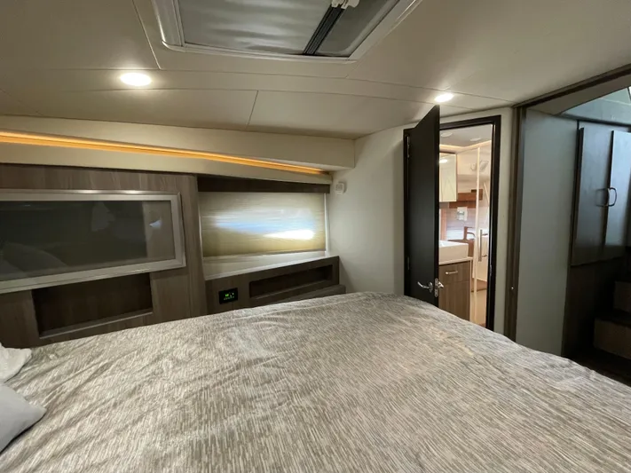 Grateful Yacht Photos Pics Luxurious interior of 2022 Regal 42 FXO yacht bedroom with modern design.