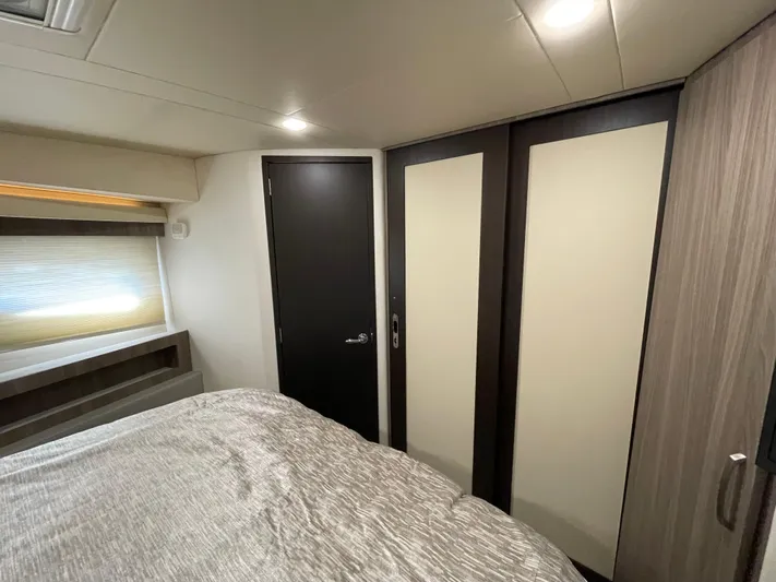 Grateful Yacht Photos Pics Interior cabin of 2022 Regal 42 FXO yacht with modern design and cozy bedding.