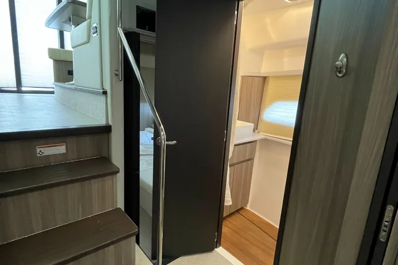 Grateful Yacht Photos Pics Interior of 2022 Regal 42 FXO yacht, featuring stairs and modern cabin design.