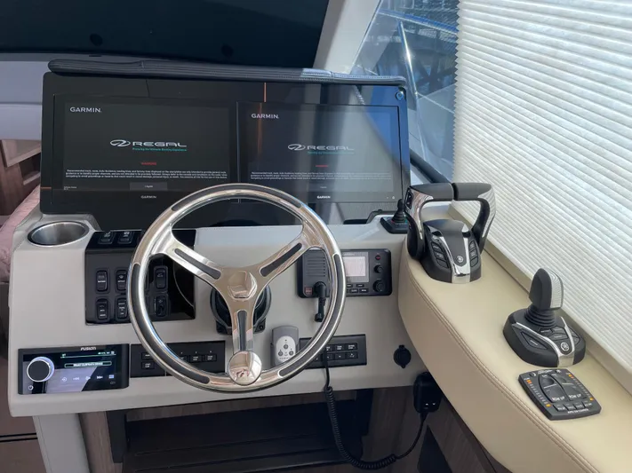 Grateful Yacht Photos Pics 2022 Regal 42 FXO helm with Garmin displays and modern controls.