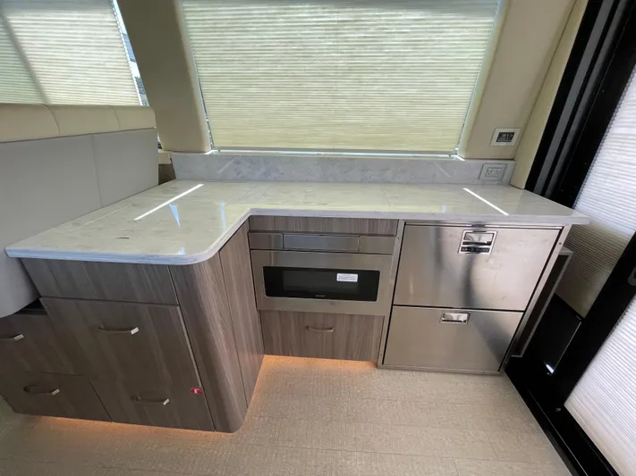 Grateful Yacht Photos Pics Modern kitchen area in 2022 Regal 42 FXO yacht with sleek cabinetry and appliances.