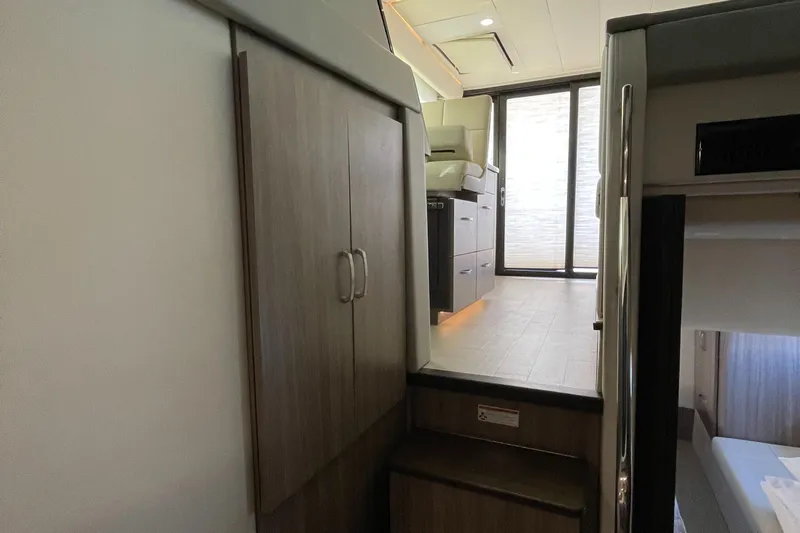 Grateful Yacht Photos Pics Interior of 2022 Regal 42 FXO yacht, featuring modern cabinetry and seating area.