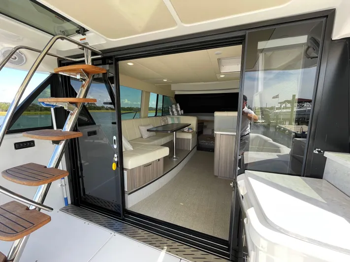 Grateful Yacht Photos Pics 2022 Regal 42 FXO yacht interior with modern seating and sleek design.