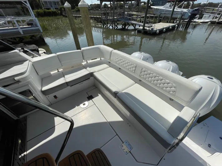 Grateful Yacht Photos Pics 2022 Regal 42 FXO boat with spacious white seating area docked at marina.