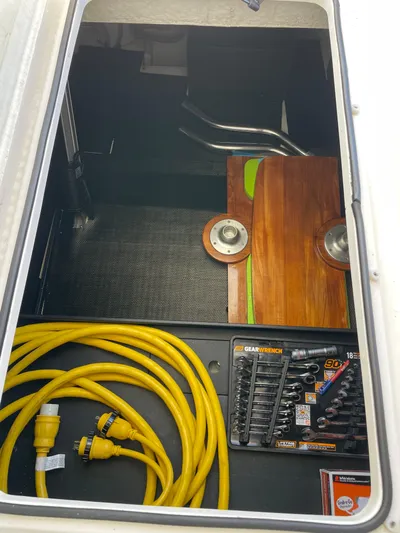 Grateful Yacht Photos Pics Storage compartment of 2022 Regal 42 FXO with tools and yellow cables.