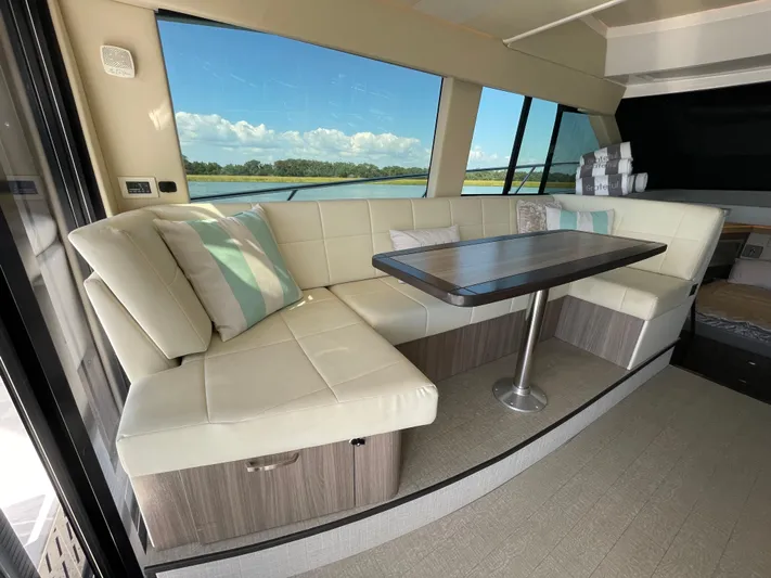 Grateful Yacht Photos Pics Luxurious interior of 2022 Regal 42 FXO yacht with plush seating and scenic view.