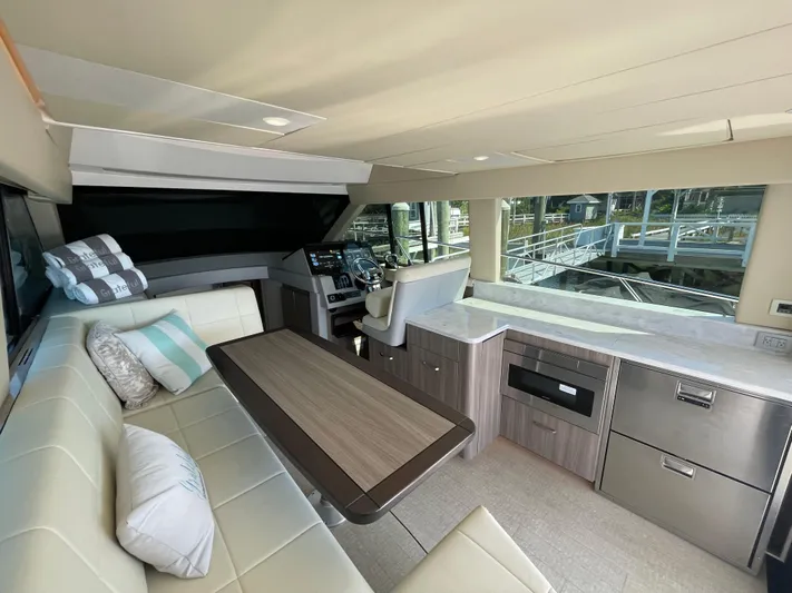 Grateful Yacht Photos Pics Luxurious interior of 2022 Regal 42 FXO yacht with modern seating and helm.
