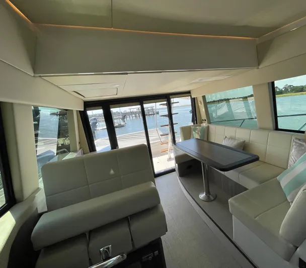 Grateful Yacht Photos Pics Luxurious interior of 2022 Regal 42 FXO yacht with spacious seating and waterfront view.