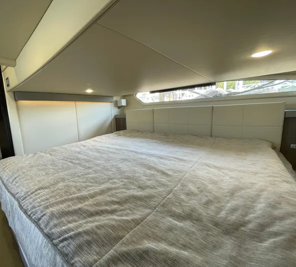Grateful Yacht Photos Pics Luxurious bedroom interior of 2022 Regal 42 FXO yacht with modern design.