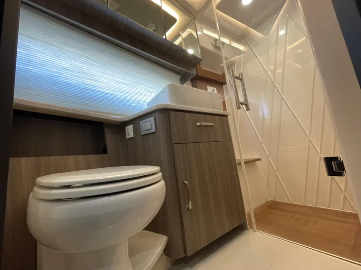 Grateful Yacht Photos Pics Luxurious bathroom in 2022 Regal 42 FXO yacht with modern fixtures and shower.