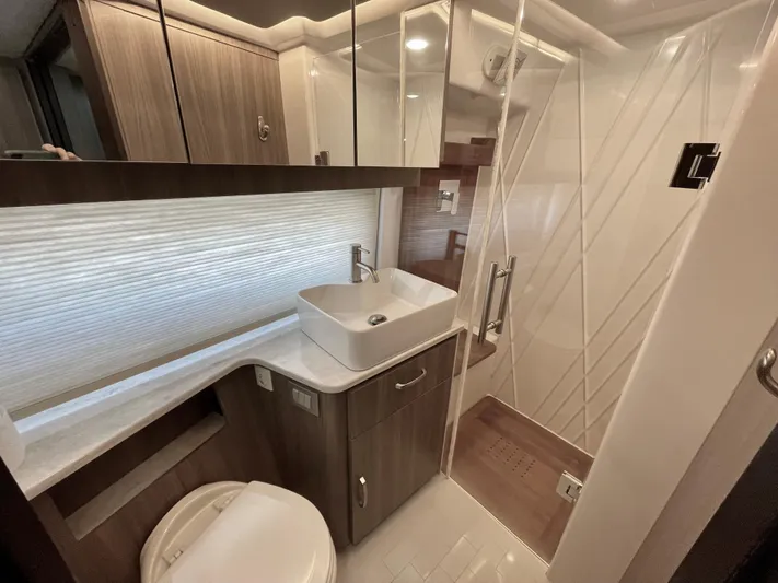 Grateful Yacht Photos Pics Luxurious bathroom in 2022 Regal 42 FXO yacht with modern fixtures and elegant design.