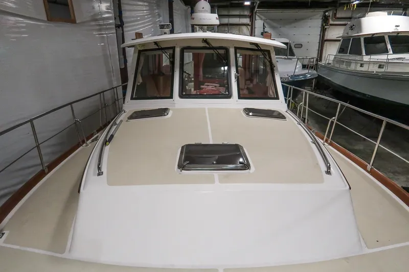 Blue Tang Yacht Photos Pics 2007 Grand Banks 39 Eastbay SX yacht in indoor storage, showcasing deck and cabin.