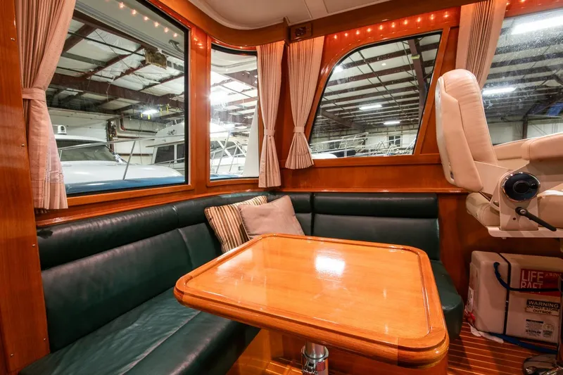Blue Tang Yacht Photos Pics Luxurious 2007 Grand Banks 39 Eastbay SX yacht interior with leather seating and wooden table.