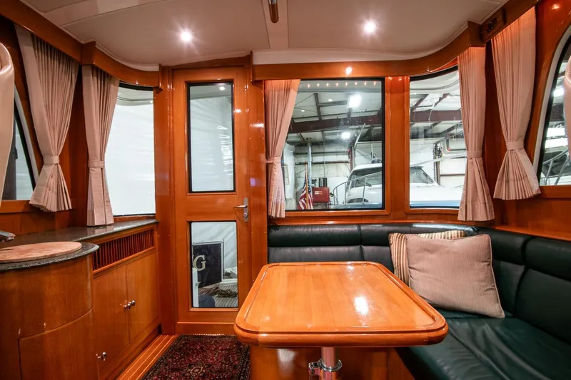 Blue Tang Yacht Photos Pics Luxurious interior of 2007 Grand Banks 39 Eastbay SX yacht with wood finishes and seating area.